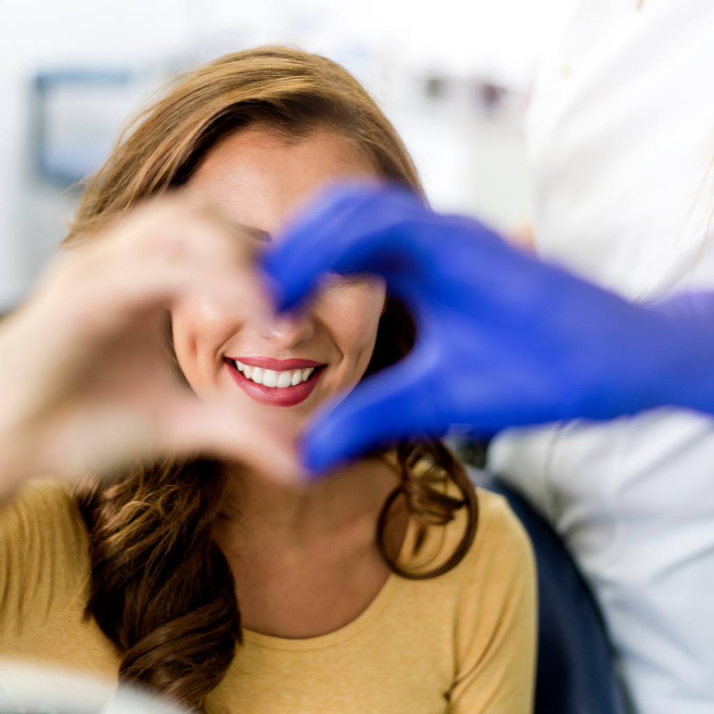 Dental anxiety and fear relieved by patient and doctor making heart shaped fingers Dentist Tinton Falls